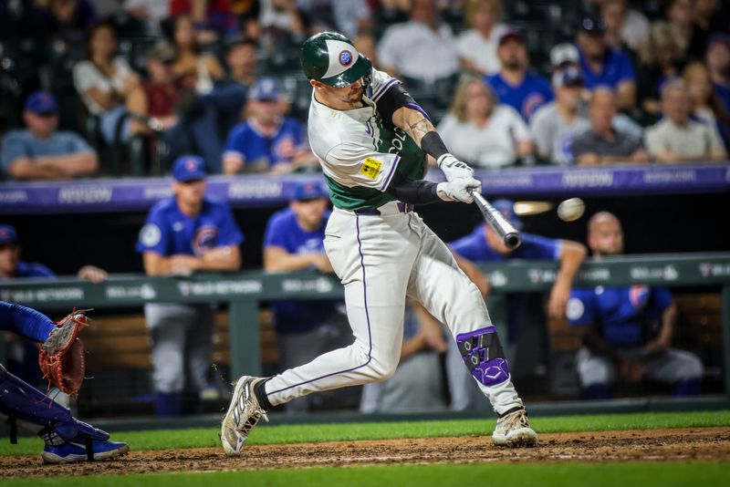 Sep 14, 2024; Denver, Colorado, USA; Colorado Rockies outfielder Brenton Doyle (9) hits the game winning run against the Chicago Cubs at Coors Field. Mandatory Credit: Chet Strange-Imagn Images
