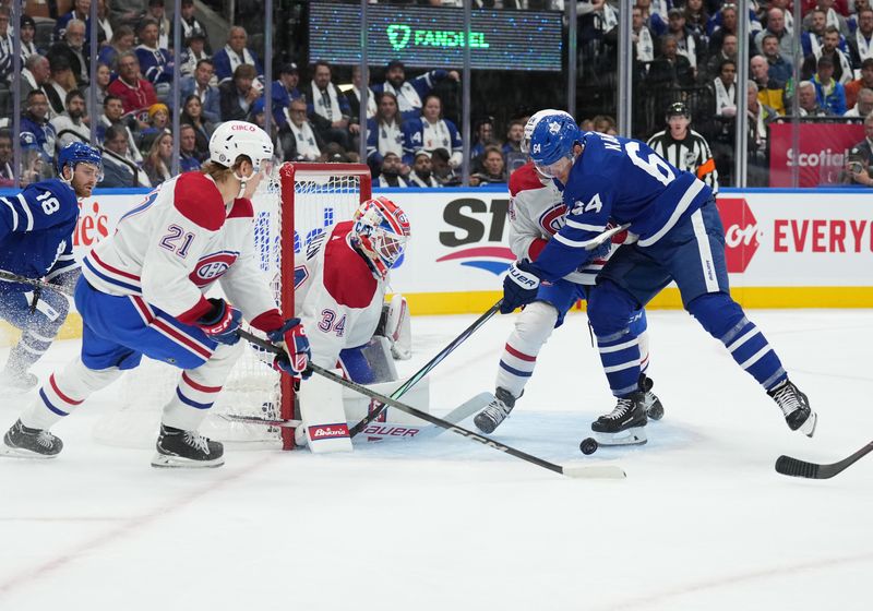 Oct 11, 2023; Toronto, Ontario, CAN; Toronto Maple Leafs center David Kampf (64) battles for  the puck in front of Montreal Canadiens goaltender Jake Allen (34) during the first period at Scotiabank Arena. Mandatory Credit: Nick Turchiaro-USA TODAY Sports