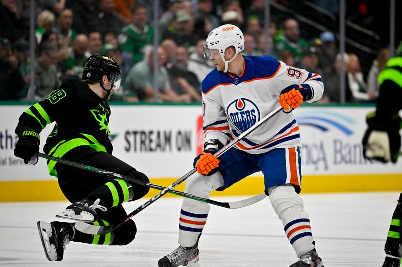 Apr 3, 2024; Dallas, Texas, USA; Dallas Stars center Sam Steel (18) is tripped up by Edmonton Oilers right wing Corey Perry (90) during the first period at the American Airlines Center. Mandatory Credit: Jerome Miron-USA TODAY Sports