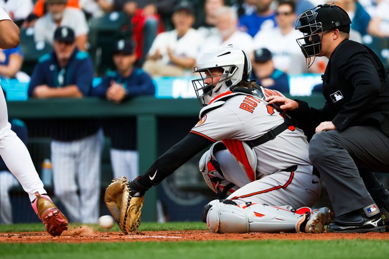 Jun 3, 2025; Seattle, Washington, USA; Baltimore Orioles catcher Adley Rutschman (35) snags a pitch in the dirt against the Seattle Mariners during the first inning at T-Mobile Park. Mandatory Credit: Joe Nicholson-Imagn Images