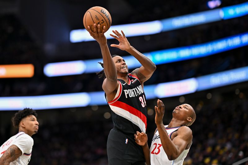 SEATTLE, WASHINGTON - OCTOBER 11: Jabari Walker #34 of the Portland Trail Blazers drives to the basket against Kai Jones #23 of the LA Clippers during the third quarter of the Rain City Showcase game at Climate Pledge Arena on October 11, 2024 in Seattle, Washington. The LA Clippers won 101-99. NOTE TO USER: User expressly acknowledges and agrees that, by downloading and or using this photograph, User is consenting to the terms and conditions of the Getty Images License Agreement. (Photo by Alika Jenner/Getty Images)