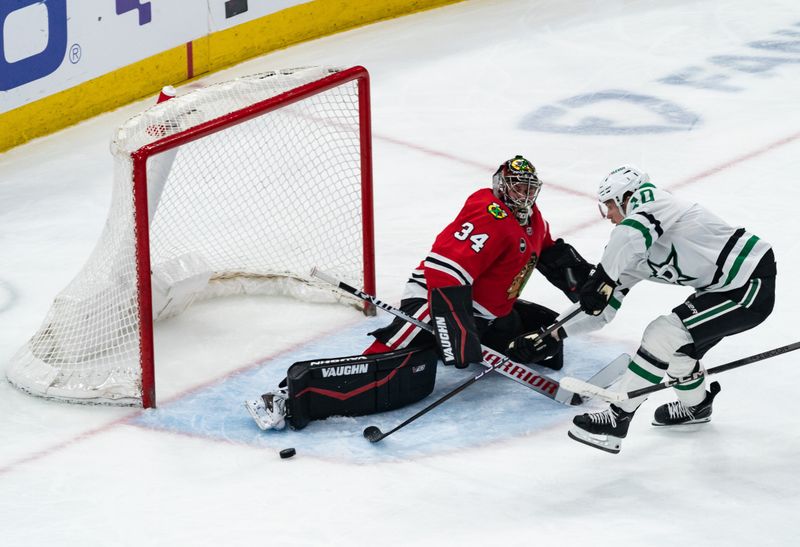 Apr 6, 2024; Chicago, Illinois, USA; Chicago Blackhawks goaltender Petr Mrazek (34) defends the goal against Dallas Stars center Ty Dellandrea (10) during the second period at United Center. Mandatory Credit: Seeger Gray-USA TODAY Sports