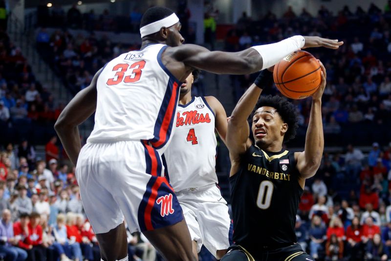 Jan 13, 2024; Oxford, Mississippi, USA; Vanderbilt Commodores guard Tyrin Lawrence (0) drives to the basket against Mississippi Rebels forward Moussa Cisse (33) during the first half at The Sandy and John Black Pavilion at Ole Miss. Mandatory Credit: Petre Thomas-USA TODAY Sports