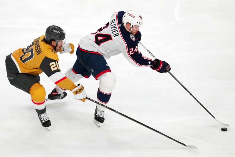 Mar 23, 2024; Las Vegas, Nevada, USA; Columbus Blue Jackets right wing Mathieu Olivier (24) controls the puck ahead of Vegas Golden Knights center Chandler Stephenson (20) during the third period at T-Mobile Arena. Mandatory Credit: Stephen R. Sylvanie-USA TODAY Sports