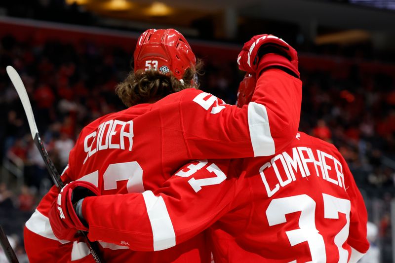 Oct 17, 2024; Detroit, Michigan, USA;  Detroit Red Wings defenseman Moritz Seider (53) receives congratulations from left wing J.T. Compher (37) after scoring in the second period against the New York Rangers at Little Caesars Arena. Mandatory Credit: Rick Osentoski-Imagn Images