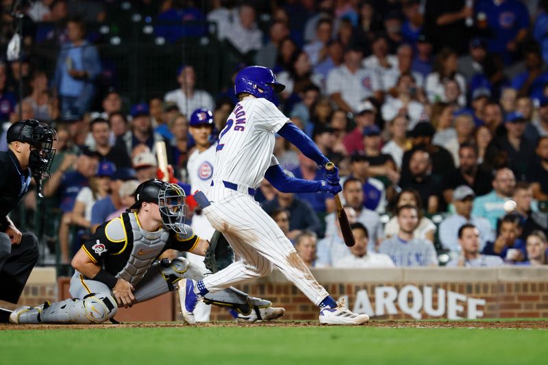 Sep 4, 2024; Chicago, Illinois, USA; Chicago Cubs outfielder Pete Crow-Armstrong (52) hits and RBI-single against the Pittsburgh Pirates during the fifth inning at Wrigley Field. Mandatory Credit: Kamil Krzaczynski-Imagn Images