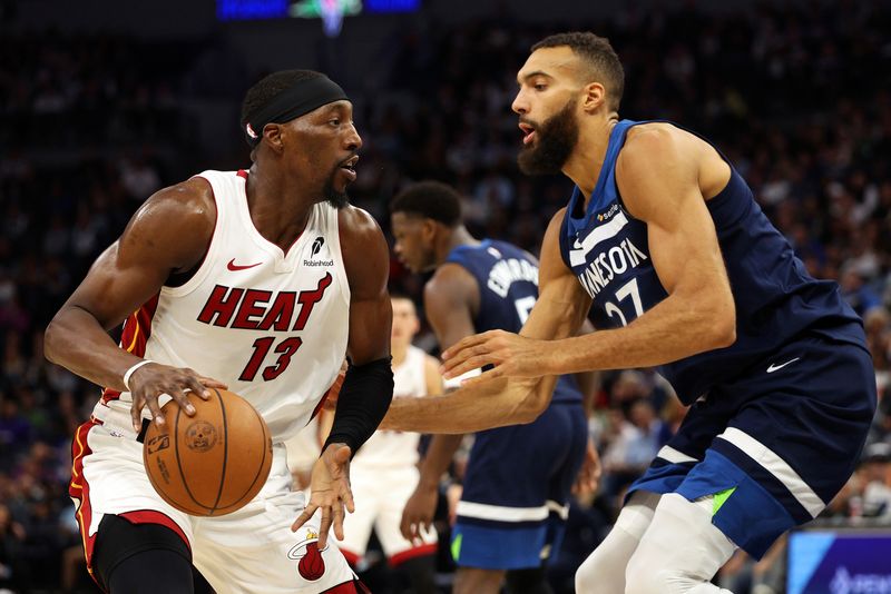 MINNEAPOLIS, MINNESOTA - NOVEMBER 10: Bam Adebayo #13 of the Miami Heat goes to the basket against Rudy Gobert #27 of the Minnesota Timberwolves in the third quarter at Target Center on November 10, 2024 in Minneapolis, Minnesota. The Heat defeated the Timberwolves 95-94. NOTE TO USER: User expressly acknowledges and agrees that, by downloading and or using this photograph, User is consenting to the terms and conditions of the Getty Images License Agreement. (Photo by David Berding/Getty Images)