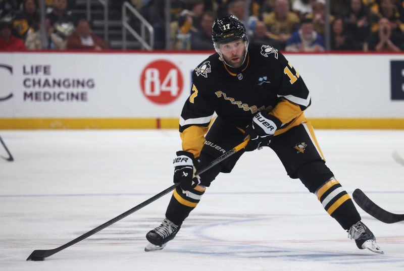 Mar 11, 2025; Pittsburgh, Pennsylvania, USA;  Pittsburgh Penguins right wing Bryan Rust (17) skates with the puck against the Vegas Golden Knights during the third period at PPG Paints Arena. Mandatory Credit: Charles LeClaire-Imagn Images