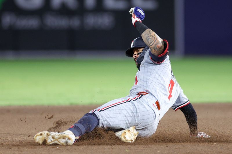 May 27, 2025; Tampa, Florida, USA; Minnesota Twins shortstop Carlos Correa (4) slides into second base against the Tampa Bay Rays in the eighth inning at George M. Steinbrenner Field. Mandatory Credit: Nathan Ray Seebeck-Imagn Images