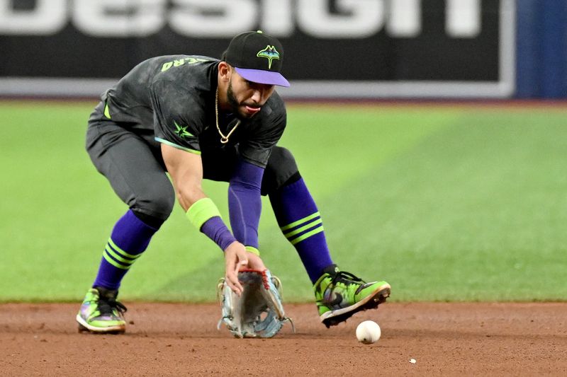 May 7, 2024; St. Petersburg, Florida, USA; Tampa Bay Rays shortstop Jose Caballero (7) fields a ground ball in the sixth inning against the Chicago White Sox at Tropicana Field. Mandatory Credit: Jonathan Dyer-USA TODAY Sports
