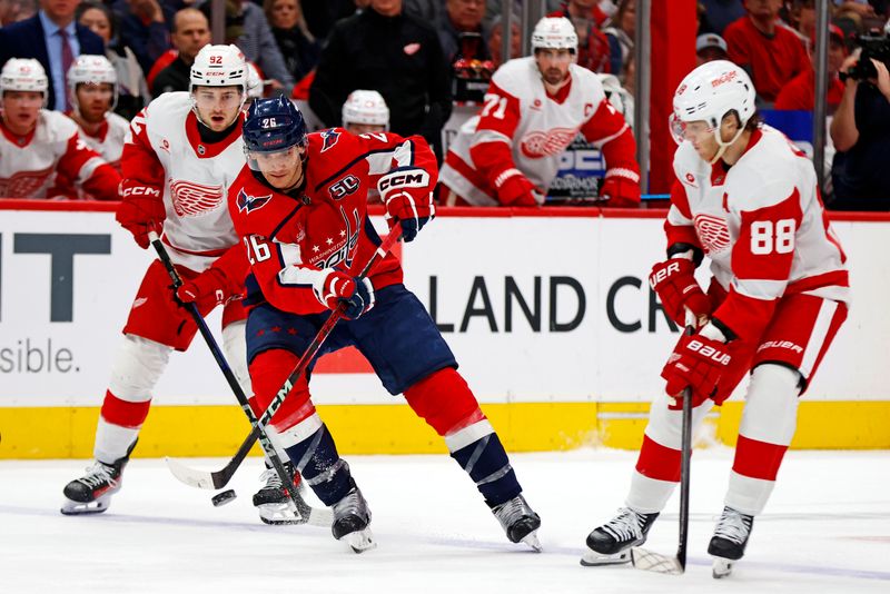 Mar 18, 2025; Washington, District of Columbia, USA; Washington Capitals center Nic Dowd (26) passes the puck against Detroit Red Wings right wing Patrick Kane (88) during the third period at Capital One Arena. Mandatory Credit: Peter Casey-Imagn Images