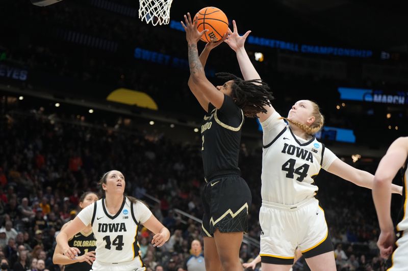 Mar 24, 2023; Seattle, WA, USA; Colorado Buffaloes guard Tameiya Sadler (2) shoots the ball against Iowa Hawkeyes forward McKenna Warnock (14) and forward Addison O'Grady (44) in the second half at Climate Pledge Arena. Mandatory Credit: Kirby Lee-USA TODAY Sports