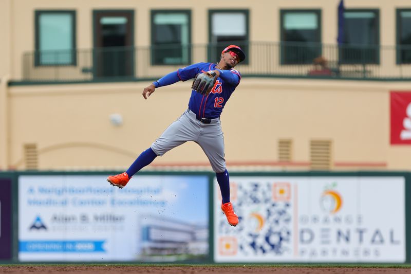 Mar 1, 2024; Jupiter, Florida, USA; New York Mets shortstop Francisco Lindor (12) jumps but cannot make a catch against the St. Louis Cardinals during the third inning at Roger Dean Chevrolet Stadium. Mandatory Credit: Sam Navarro-USA TODAY Sports