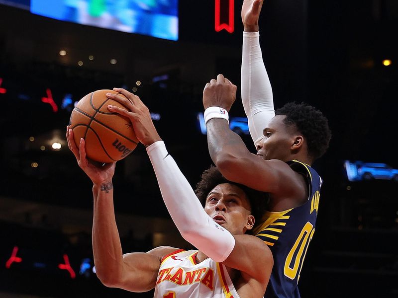 ATLANTA, GEORGIA - OCTOBER 08:  Jalen Johnson #1 of the Atlanta Hawks drives against Bennedict Mathurin #00 of the Indiana Pacers during the first quarter at State Farm Arena on October 08, 2024 in Atlanta, Georgia.  NOTE TO USER: User expressly acknowledges and agrees that, by downloading and/or using this photograph, user is consenting to the terms and conditions of the Getty Images License Agreement.  (Photo by Kevin C. Cox/Getty Images)