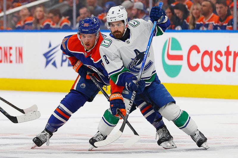 May 12, 2024; Edmonton, Alberta, CAN;Edmonton Oilers forward Dylan Holloway (55) and Vancouver Canucks forward Conor Garland (8) battles for position  during the first period in game three of the second round of the 2024 Stanley Cup Playoffs at Rogers Place. Mandatory Credit: Perry Nelson-USA TODAY Sports