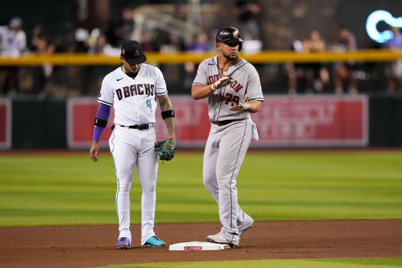 Sep 30, 2023; Phoenix, Arizona, USA; Houston Astros first baseman Jose Abreu (79) reacts in front of Arizona Diamondbacks second baseman Ketel Marte (4) after hitting an RBI double against the Arizona Diamondbacks during the fourth inning at Chase Field. Mandatory Credit: Joe Camporeale-USA TODAY Sports