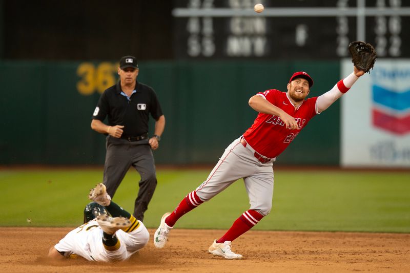 Jul 3, 2024; Oakland, California, USA; Oakland Athletics catcher Shea Langeliers (23) slides safely into second base with a steal as Los Angeles Angels second baseman Brandon Drury (23) reaches for the errant throw during the sixth inning at Oakland-Alameda County Coliseum. Mandatory Credit: D. Ross Cameron-USA TODAY Sports