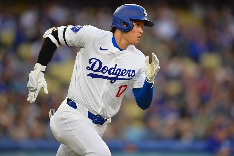 May 22, 2024; Los Angeles, California, USA; Los Angeles Dodgers designated hitter Shohei Ohtani (17) runs after hitting a single against the Arizona Diamondbacks during the first inning at Dodger Stadium. Mandatory Credit: Gary A. Vasquez-USA TODAY Sports