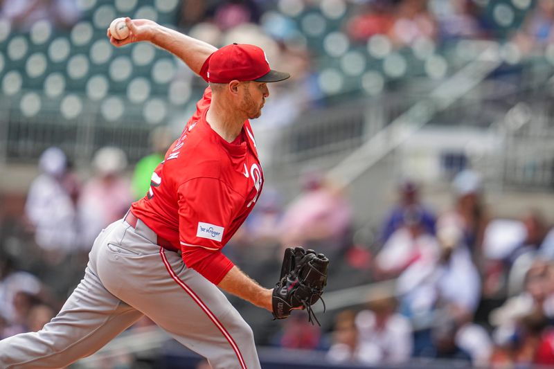 Jul 24, 2024; Cumberland, Georgia, USA; Cincinnati Reds relief pitcher Justin Wilson (32) pitches against the Atlanta Braves during the ninth inning at Truist Park. Mandatory Credit: Dale Zanine-USA TODAY Sports