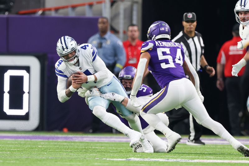 Minnesota Vikings defensive tackle Harrison Phillips (97) sacks Dallas Cowboys quarterback Dak Prescott (4) during the first half of an NFL football game Sunday, Nov. 20, 2022 in Minneapolis. (AP Photo/Stacy Bengs)