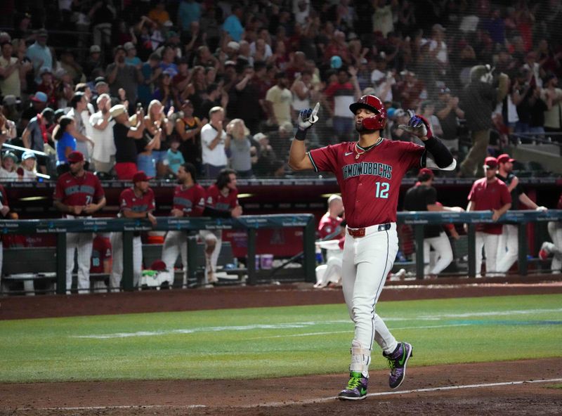 Jul 28, 2024; Phoenix, Arizona, USA; Arizona Diamondbacks outfielder Lourdes Gurriel Jr. (12) celebrates after hitting a solo home run against the Pittsburgh Pirates during the tenth inning at Chase Field. Mandatory Credit: Joe Camporeale-USA TODAY Sports