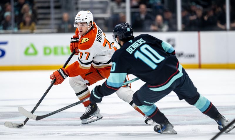 Jan 28, 2025; Seattle, Washington, USA;  Anaheim Ducks forward Frank Vatrano (77) skatea against Seattle Kraken forward Matty Beniers (10) during the first period at Climate Pledge Arena. Mandatory Credit: Stephen Brashear-Imagn Images