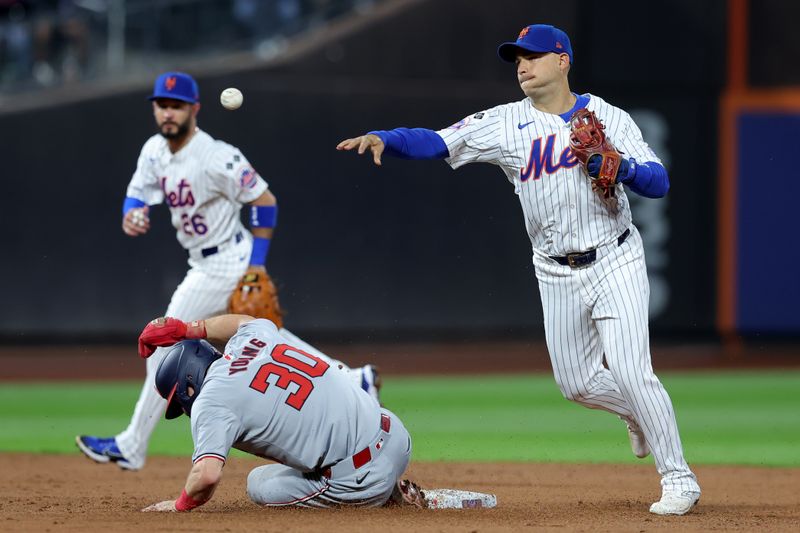 Sep 16, 2024; New York City, New York, USA; New York Mets second baseman Jose Iglesias (11) forces out Washington Nationals center fielder Jacob Young (30) at second base and throws to first to try and complete a double play on a ground ball by Nationals right fielder Dylan Crews (not pictured) during the third inning at Citi Field. Crews was safe at first base. Mandatory Credit: Brad Penner-Imagn Images