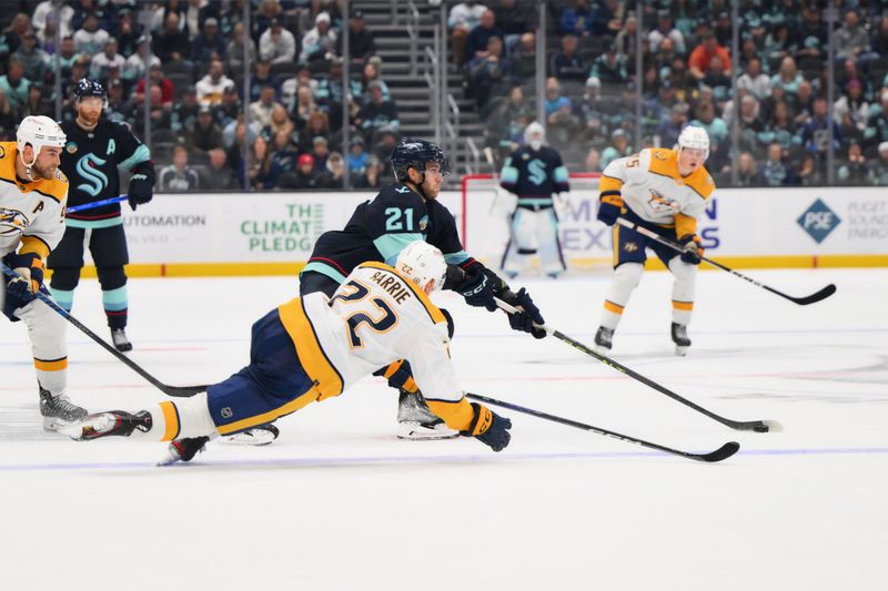 Nov 2, 2023; Seattle, Washington, USA; Seattle Kraken center Alex Wennberg (21) plays the puck while Nashville Predators defenseman Tyson Barrie (22) plays defense during the third period at Climate Pledge Arena. Mandatory Credit: Steven Bisig-USA TODAY Sports