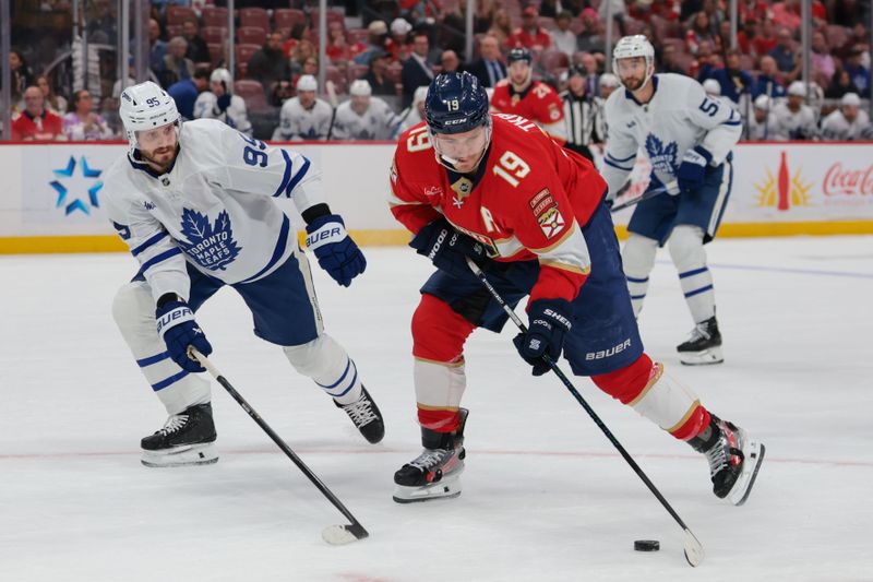 Feb 26, 2026; Sunrise, Florida, USA; Florida Panthers left wing Matthew Tkachuk (19) moves the puck against Toronto Maple Leafs defenseman Oliver Ekman-Larsson (95) during the first period at Amerant Bank Arena. Mandatory Credit: Sam Navarro-Imagn Images