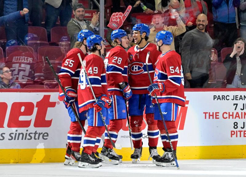 Apr 9, 2024; Montreal, Quebec, CAN; Montreal Canadiens forward Christian Dvorak (28) celebrates with teammates after scoring a goal against the Philadelphia Flyers during the first period at the Bell Centre. Mandatory Credit: Eric Bolte-USA TODAY Sports