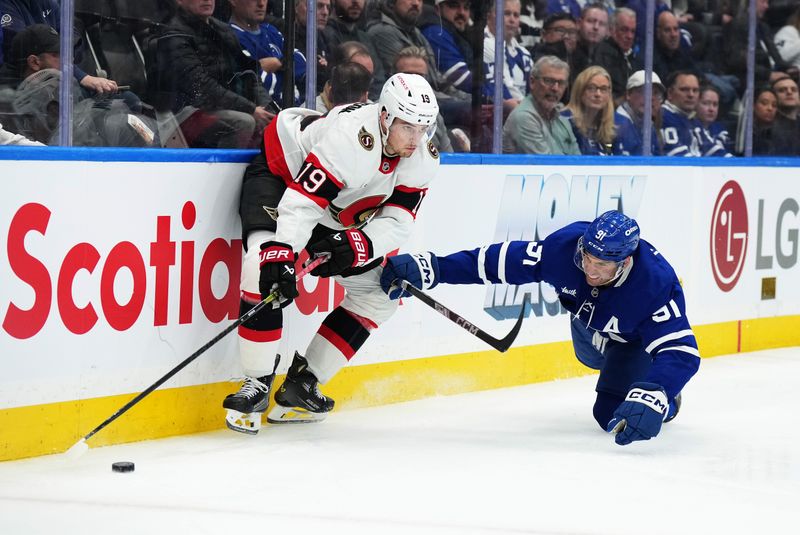 Nov 12, 2024; Toronto, Ontario, CAN; Toronto Maple Leafs center John Tavares (91) battles for the puck with Ottawa Senators right wing Drake Batherson (19) during the third period at Scotiabank Arena. Mandatory Credit: Nick Turchiaro-Imagn Images