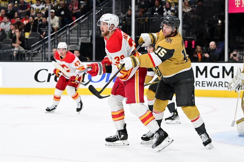 Oct 28, 2024; Las Vegas, Nevada, USA; Vegas Golden Knights defenseman Noah Hanifin (15) and Calgary Flames right wing Anthony Mantha (39) battle for position in the third period at T-Mobile Arena. Mandatory Credit: Candice Ward-Imagn Images