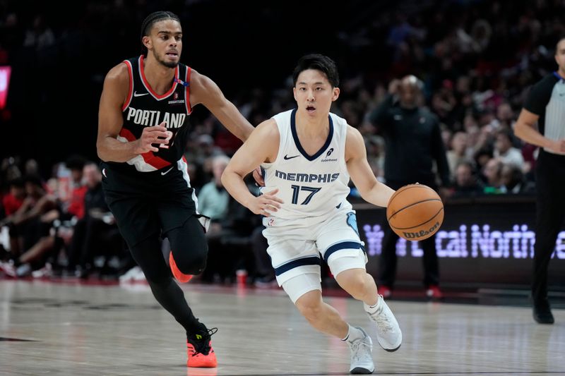 PORTLAND, OREGON - NOVEMBER 10: Yuki Kawamura #17 of the Memphis Grizzlies dribbles the ball against Rayan Rupert #21 of the Portland Trail Blazers during the second half at Moda Center on November 10, 2024 in Portland, Oregon. NOTE TO USER: User expressly acknowledges and agrees that, by downloading and or using this photograph, User is consenting to the terms and conditions of the Getty Images License Agreement. (Photo by Soobum Im/Getty Images)