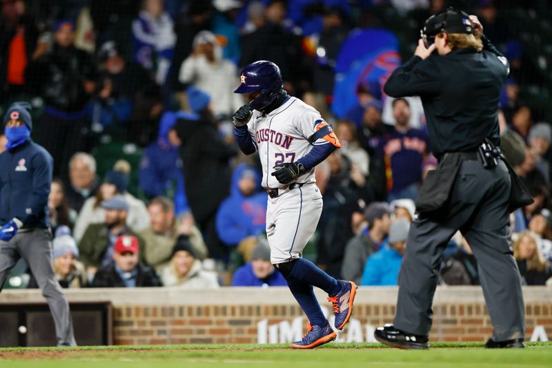 Apr 24, 2024; Chicago, Illinois, USA; Houston Astros second baseman Jose Altuve (27) crosses home plate after hitting a solo home run against the Chicago Cubs during the ninth inning at Wrigley Field. Mandatory Credit: Kamil Krzaczynski-USA TODAY Sports