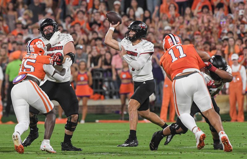 Nov 2, 2024; Clemson, South Carolina, USA; Louisville Cardinals quarterback Tyler Shough (9) throws against Clemson Tigers defensive end Jahiem Lawson (15) and defensive lineman Peter Woods (11) during the first quarter at Memorial Stadium. Mandatory Credit: Ken Ruinard-Imagn Images