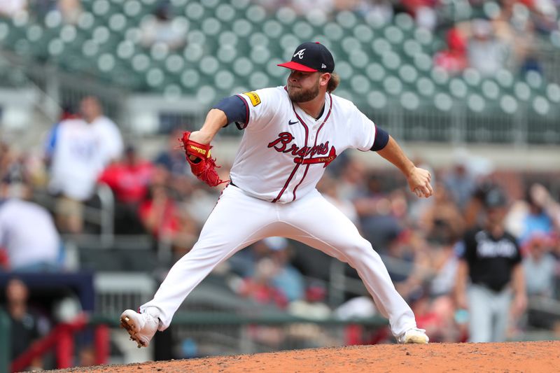 Aug 4, 2024; Cumberland, Georgia, USA; Atlanta Braves relief pitcher A.J. Minter (33) pitches during a game against the Miami Marlins in the ninth inning at Truist Park. Mandatory Credit: Mady Mertens-USA TODAY Sports