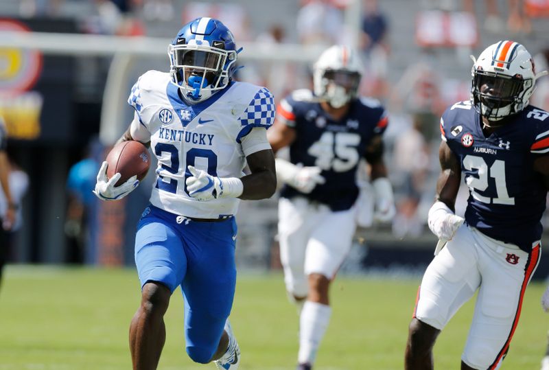 Sep 26, 2020; Auburn, Alabama, USA;  Kentucky Wildcats running back Kavosiey Smoke (20) gets past Auburn Tigers defenders and scores a touchdown during the first quarter at Jordan-Hare Stadium. Mandatory Credit: John Reed-USA TODAY Sports