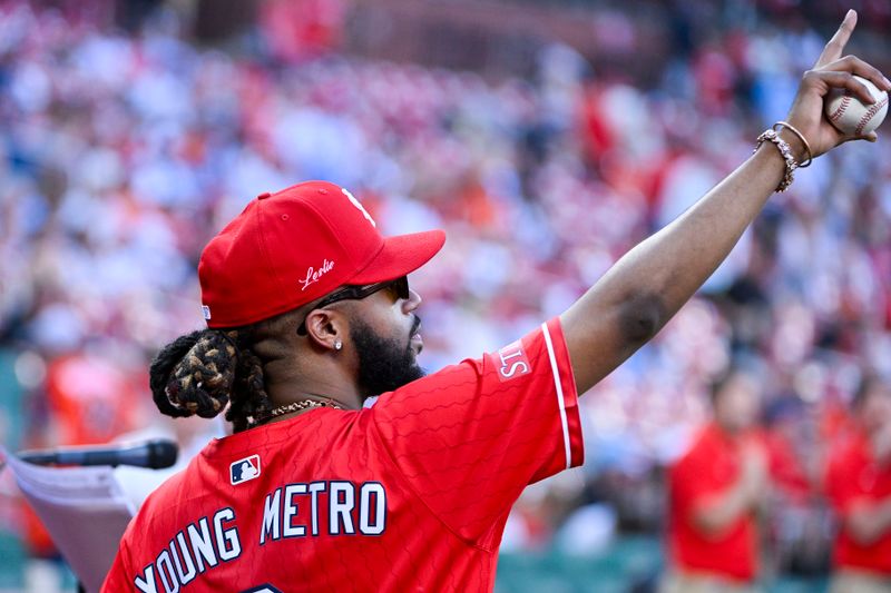 May 20, 2024; St. Louis, Missouri, USA;  St. Louis native and American record producer Metro Boomin walks out to through out a first pitch wearing the St. Louis Cardinals City Connect jersey before a game against the Baltimore Orioles at Busch Stadium. Mandatory Credit: Jeff Curry-USA TODAY Sports