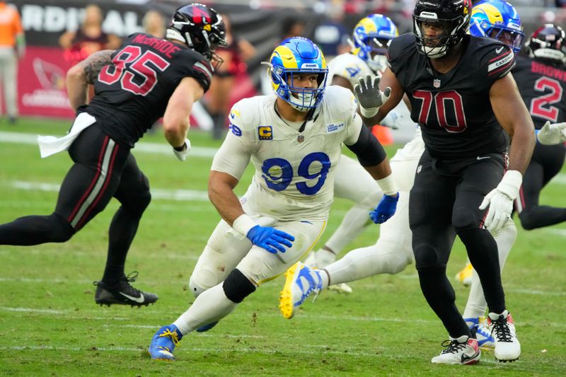 Los Angeles Rams defensive tackle Aaron Donald (99) lines up against the Arizona Cardinals during the first half of an NFL football game, Sunday, Nov. 26, 2023, in Glendale, Ariz. (AP Photo/Rick Scuteri)