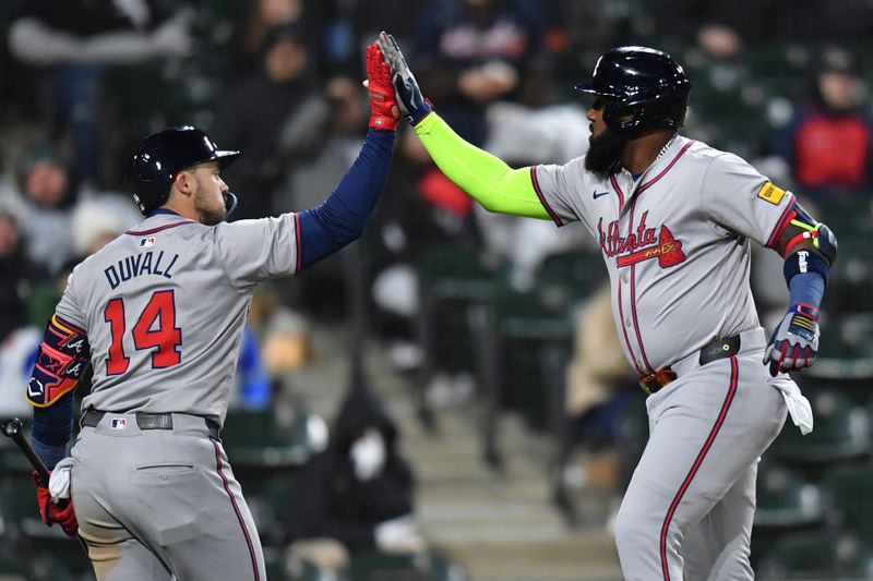 Apr 2, 2024; Chicago, Illinois, USA; Atlanta Braves designated hitter Marcell Ozuna (20) celebrates his solo home run with left fielder Adam Duvall (14) during the ninth inning against the Chicago White Sox at Guaranteed Rate Field. Mandatory Credit: Patrick Gorski-USA TODAY Sports