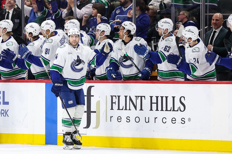 Dec 3, 2024; Saint Paul, Minnesota, USA; Vancouver Canucks left wing Jake DeBrusk (74) celebrates his goal with teammates against the Minnesota Wild during the second period at Xcel Energy Center. Mandatory Credit: Matt Krohn-Imagn Images