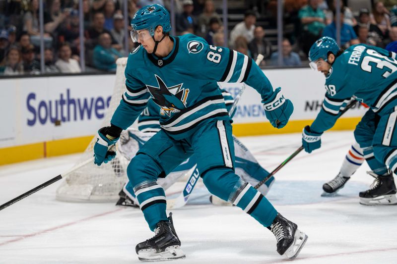 Feb 28, 2026; San Jose, California, USA; San Jose Sharks defenseman Shakir Mukhamadullin (85) chase down the puck against the Edmonton Oilers during the first period at SAP Center at San Jose. Mandatory Credit: Neville E. Guard-Imagn Images