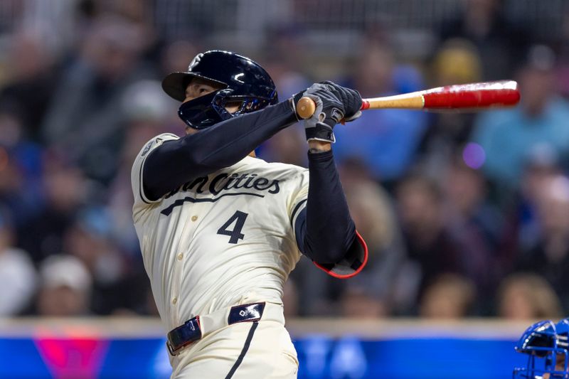Apr 9, 2024; Minneapolis, Minnesota, USA; Minnesota Twins shortstop Carlos Correa (4) hits a solo home run against the Los Angeles Dodgers in the ninth inning at Target Field. Mandatory Credit: Jesse Johnson-USA TODAY Sports