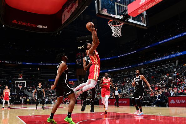 ATLANTA, GA - DECEMBER 6: De'Andre Hunter #12 of the Atlanta Hawks drives to the basket during the game against the Brooklyn Nets on December 6, 2023 at State Farm Arena in Atlanta, Georgia.  NOTE TO USER: User expressly acknowledges and agrees that, by downloading and/or using this Photograph, user is consenting to the terms and conditions of the Getty Images License Agreement. Mandatory Copyright Notice: Copyright 2023 NBAE (Photo by Scott Cunningham/NBAE via Getty Images)