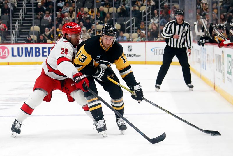 Oct 18, 2024; Pittsburgh, Pennsylvania, USA;  Carolina Hurricanes left wing William Carrier (28) pressures Pittsburgh Penguins right wing Kevin Hayes (13) during the third period at PPG Paints Arena. Mandatory Credit: Charles LeClaire-Imagn Images