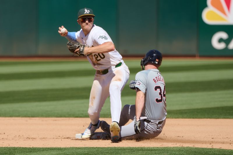 Sep 7, 2024; Oakland, California, USA; Oakland Athletics infielder Zack Gelof (20) throws the ball to first base against Detroit Tigers catcher Jake Rogers (34) during the seventh inning at Oakland-Alameda County Coliseum. Mandatory Credit: Robert Edwards-Imagn Images