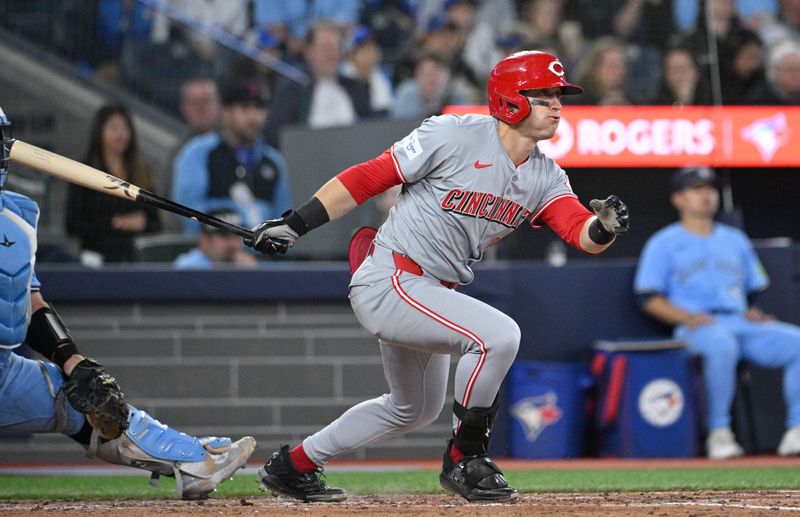 Aug 19, 2024; Toronto, Ontario, CAN; Cincinnati Reds center fielder TJ Friedl (29) hits a single against the Toronto Blue Jays in the sixth inning at Rogers Centre. Mandatory Credit: Dan Hamilton-USA TODAY Sports