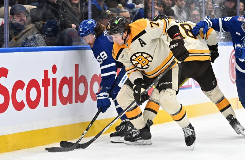 Dec 2, 2023; Toronto, Ontario, CAN; Boston Bruins defenseman Charlie McAvoy (73) battles for the puck with Toronto Maple Leafs forward Tyler Bertuzzi (59) in the third  period at Scotiabank Arena. Mandatory Credit: Dan Hamilton-USA TODAY Sports