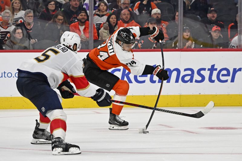 Oct 13, 2025; Philadelphia, Pennsylvania, USA; Philadelphia Flyers right wing Owen Tippett (74) takes a shot on goal against Florida Panthers defenseman Aaron Ekblad (5) during the second period at Wells Fargo Center. Mandatory Credit: Eric Hartline-Imagn Images