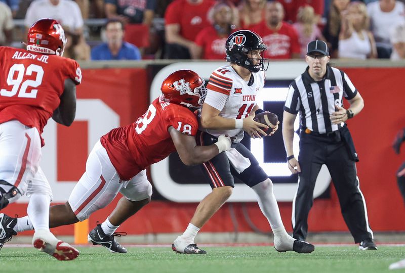 Oct 26, 2024; Houston, Texas, USA; Houston Cougars defensive lineman Anthony Holmes Jr. (18) attempts to tackle Utah Utes quarterback Isaac Wilson (11) during the second quarter at TDECU Stadium. Mandatory Credit: Troy Taormina-Imagn Images